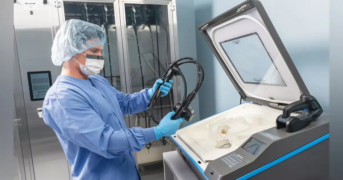A STERIS technician carefully cleans and disinfects an endoscope within an Endoscope Washer Disinfector (EWD), adhering to strict sterilisation protocols to ensure patient safety.