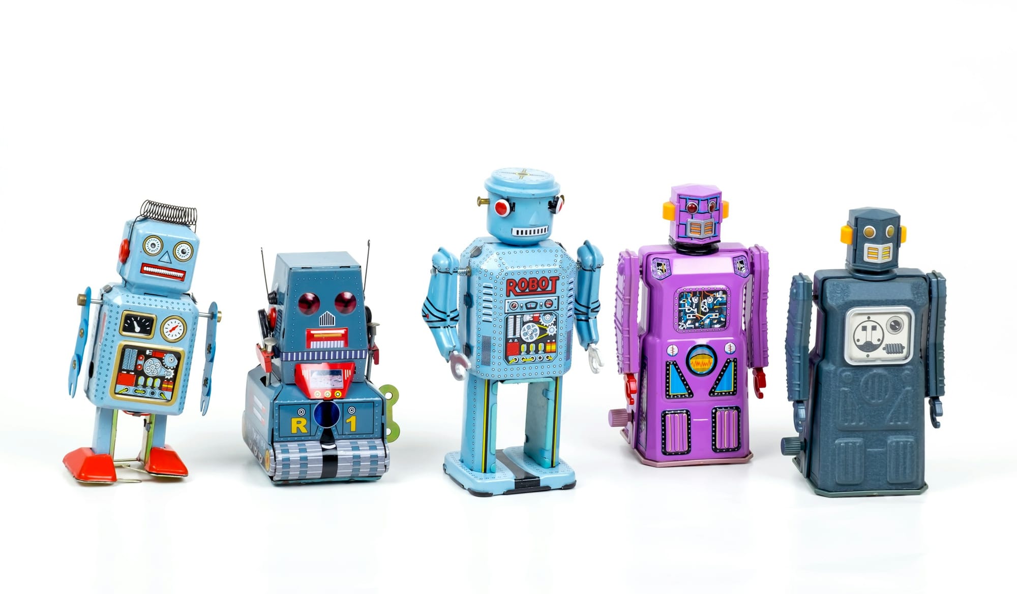 Five vintage toy robots in blue, purple, and grey lined up on white background representing AI as tools for UX research.